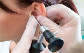 Otoscope ear check during a hearing evaluation